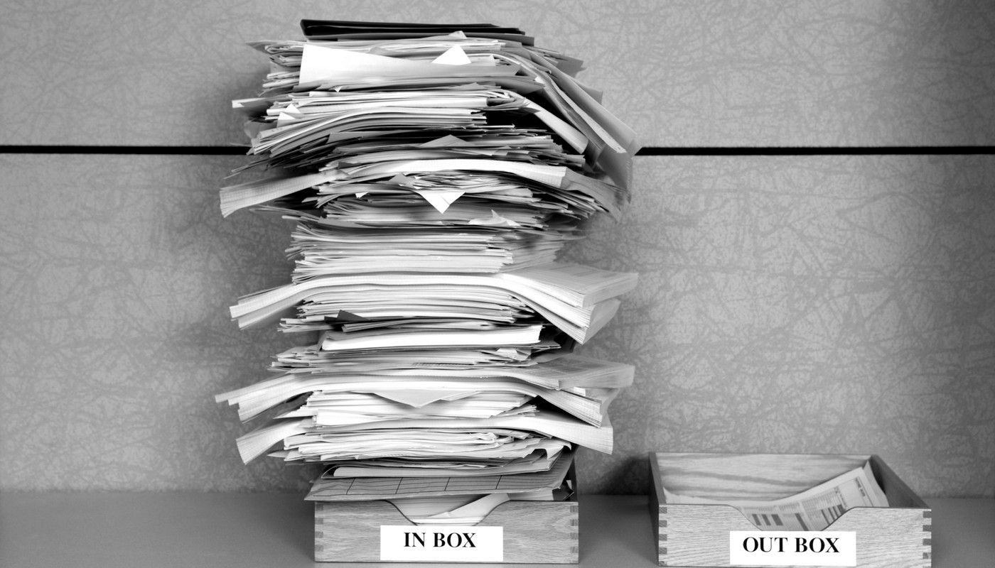 A stack of papers on two office trays