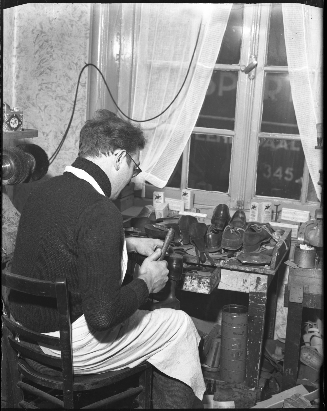 A shoemaker at his bench, Amsterdam, January 1950